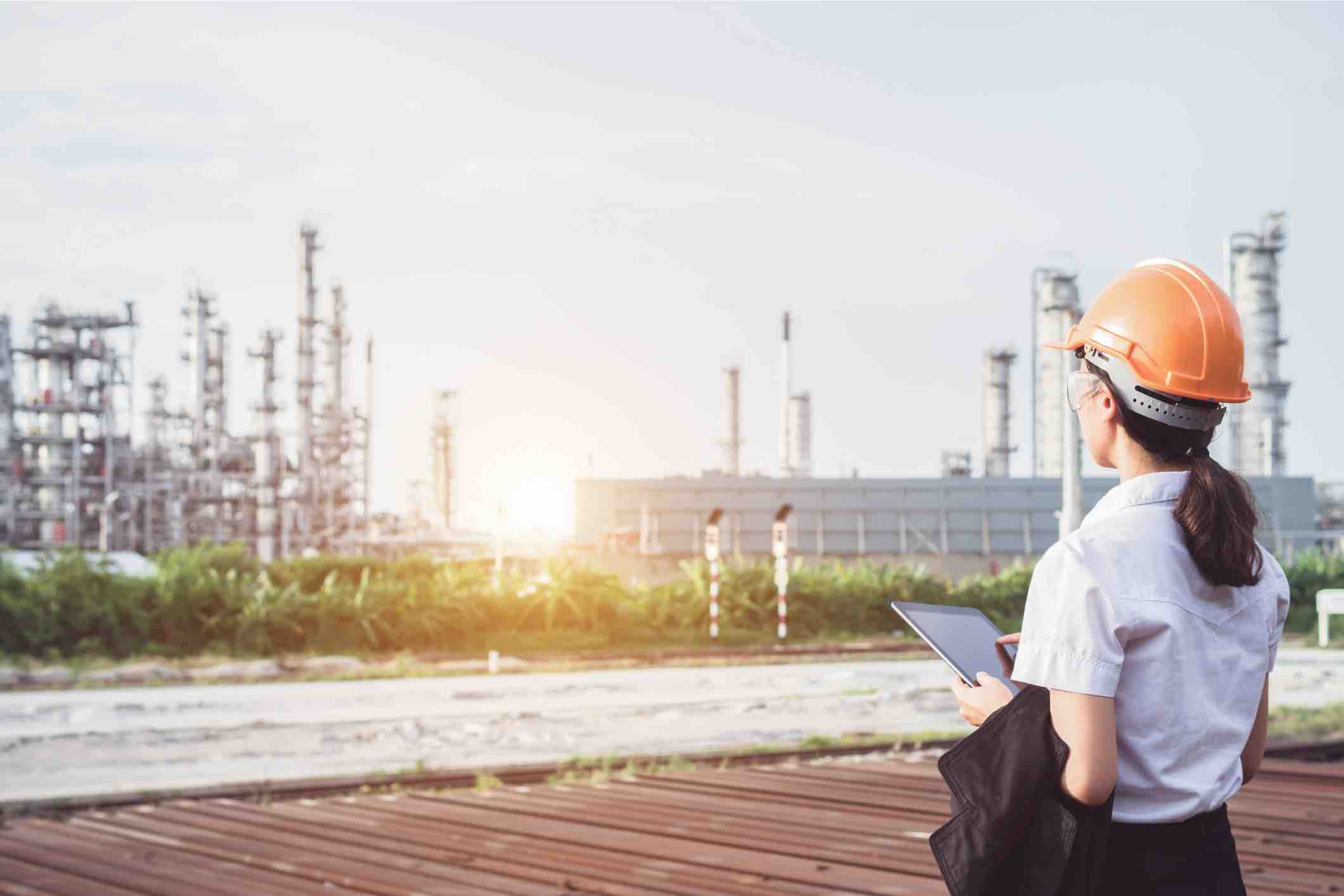 A women standing and looking over an industry.