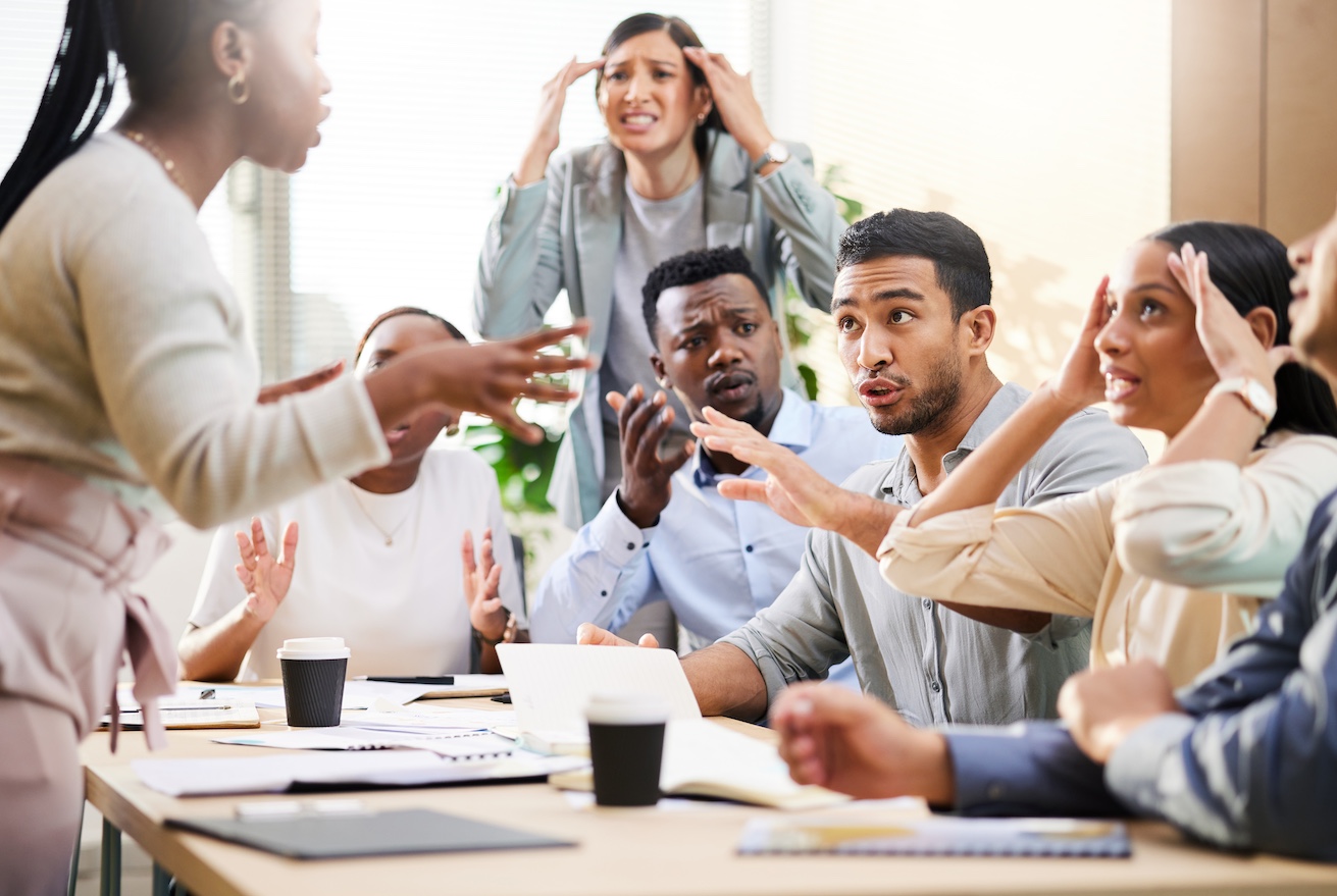 Cropped shot of a diverse group of businesspeople arguing during a meeting in the boardroom