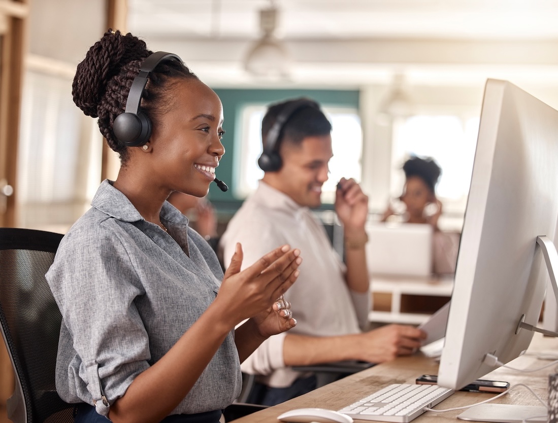 Inside sales, woman and smile at computer for telemarketing, sales and global support. Professional female consultant or agent with a headset and team for customer service, crm and help desk advice