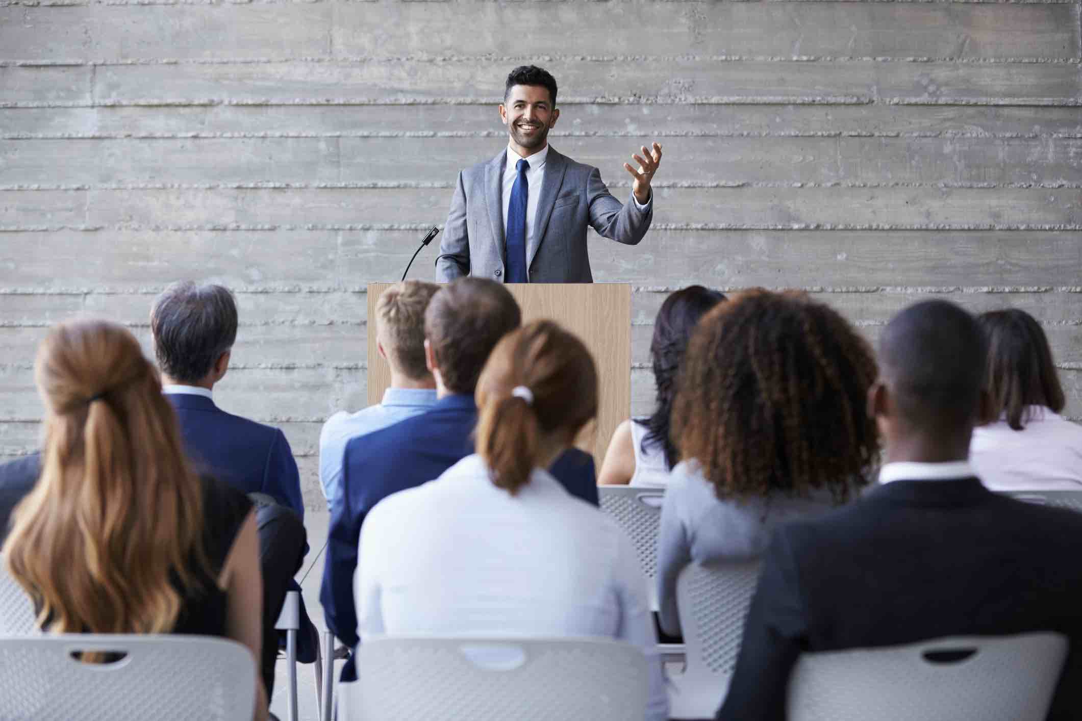 Businessman Addressing Delegates At Conference