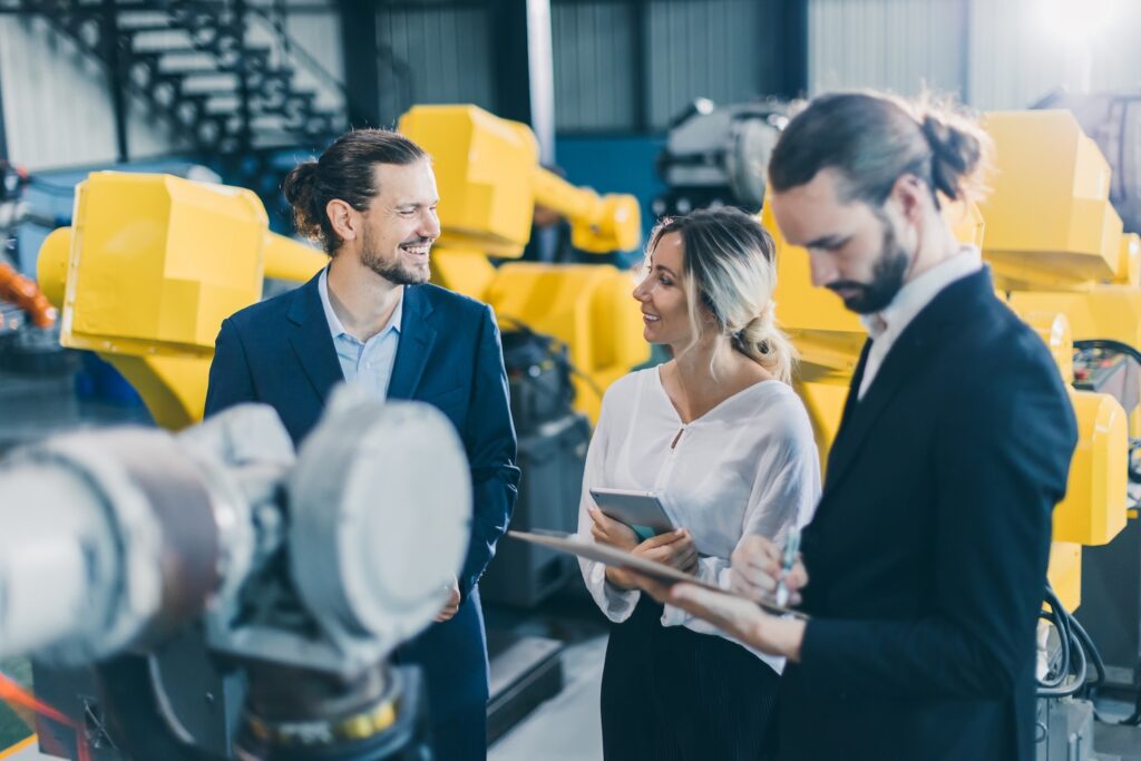 Manufacturing salesperson marketing team working introduces modern technology machine products to lady business customer happy smile