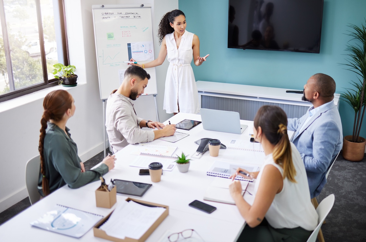 Sales training classroom, instructor leading in-person training.